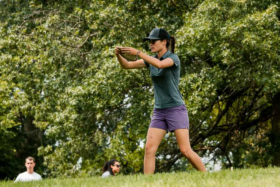 A Photo of Kona Panis, Professional Disc Golf Player Putting In Tournament