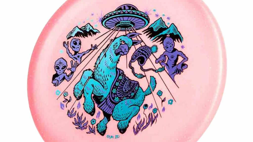 An Infinite Discs Metal Flake Glow C-Blend Alpaca Light Pink-ish Color disc with Light blue/Purple stamp